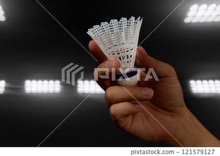 Hand holding a badminton shuttlecock Hand holding a badminton shuttlecock 121579127