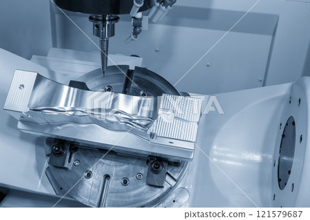 The 5-axis CNC milling machine cutting the automotive part with solid ball end mill tool in the light blue scene. The 5-axis CNC milling machine cutting the automotive part with solid ball end mill tool in the light blue scene. 121579687