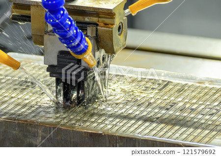 The EDM machine working with liquid coolant method. 121579692