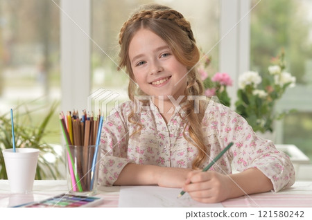 Cute smiling little girl drawing at home Cute smiling little girl drawing at home 121580242