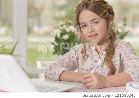 Cute and happy little girl children using laptop computer 121580243
