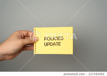 Policies update concept. Man holding a note with words. Process of revising, modifying, or creating new policies to ensure they remain relevant, effective, and aligned with current standards Policies update concept. Man holding a note with words. Process of revising, modifying, or creating new policies to ensure they remain relevant, effective, and aligned with current standards 121582082