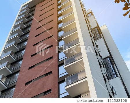 View of multi-storey buildings in a modern residential complex on a sunny day a blue sky background. Skyscrapers and real estate 121582106