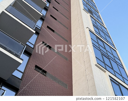 View of multi-storey buildings in a modern residential complex on a sunny day a blue sky background. Skyscrapers and real estate View of multi-storey buildings in a modern residential complex on a sunny day a blue sky background. Skyscrapers and real estate 121582107