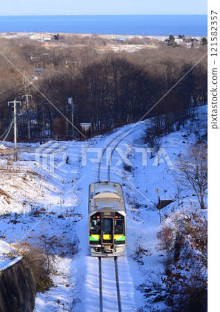 A local train (following behind) passes through the Naobetsu Tunnel and heads back to the village of Shakubetsu on the Pacific coast. A local train (following behind) passes through the Naobetsu Tunnel and heads back to the village of Shakubetsu on the Pacific coast. 121582357