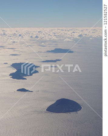 The Izu Islands in the Pacific Ocean, including Toshima, Udonejima, Niijima, Shikinejima, and Kozushima, seen from the air above Izu Oshima. 121582527
