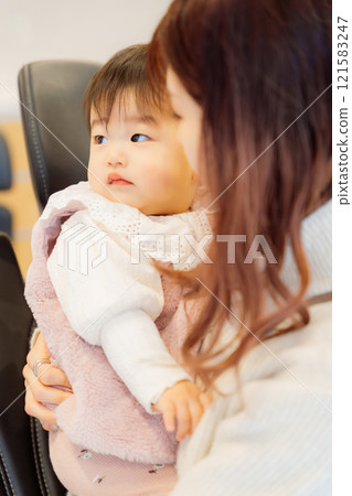 Infant and mother undergoing infant check-up Infant and mother undergoing infant check-up 121583247