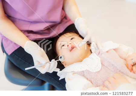 An anxious baby undergoing an infant checkup An anxious baby undergoing an infant checkup 121583277