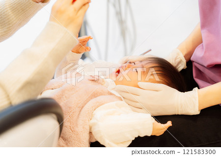 An anxious baby undergoing an infant checkup An anxious baby undergoing an infant checkup 121583300