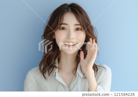 Woman screaming with hands in front of mouth 121584226