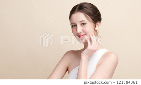 Beautiful young woman with clean fresh skin on beige background, Face care, Facial treatment, Cosmetology, beauty and spa, women portrait. 121584361