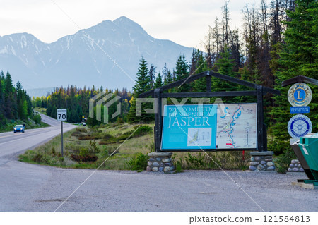Jasper, Alberta, Canada - June 2 2021 : Welcome to Jasper road sign. Icefields Parkway (Alberta Highway 93) to the town of Jasper. Pyramid Mountain in the background. Jasper, Alberta, Canada - June 2 2021 : Welcome to Jasper road sign. Icefields Parkway (Alberta Highway 93) to the town of Jasper. Pyramid Mountain in the background. 121584813