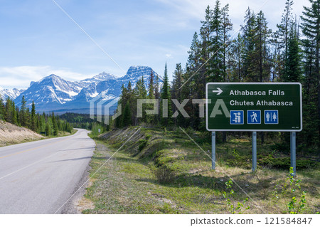 Road sign to Athabasca Falls on Icefields Parkway (Alberta Highway 93) in Jasper National Park, Alberta, Canada. Canadian Rockies summer landscape. Mount Fryatt and Geraldine Peak in the background. 121584847