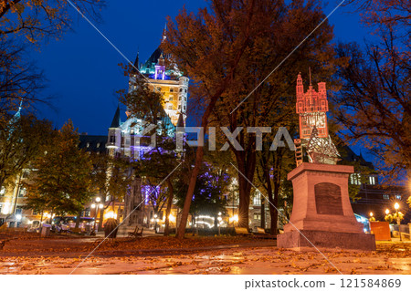 Quebec, Canada - October 18 2021 : Night view of the Quebec City Old Town in autumn. Place d'Armes, landscaped plaza with a fountain. Quebec, Canada - October 18 2021 : Night view of the Quebec City Old Town in autumn. Place d'Armes, landscaped plaza with a fountain. 121584869