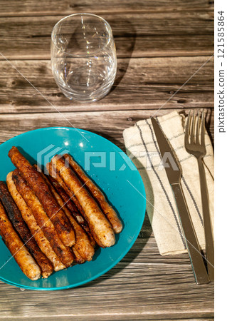 Authentic food with roasted sausage, served in plate with cutlery. German food concept 121585864