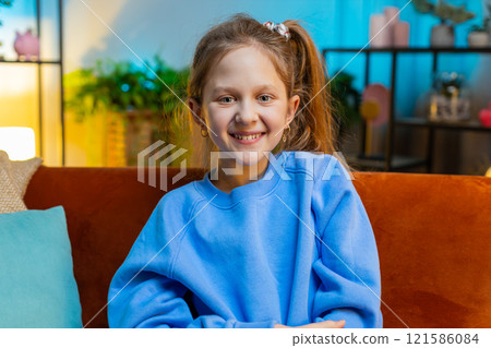 Portrait of happy smiling Caucasian preteen school girl child kid looking at camera, home play room Portrait of happy smiling Caucasian preteen school girl child kid looking at camera, home play room 121586084