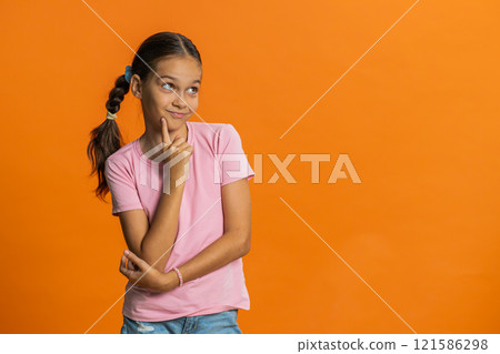 Thoughtful clever young preteen child girl kid pondering a solution doubting question brainstorming 121586298