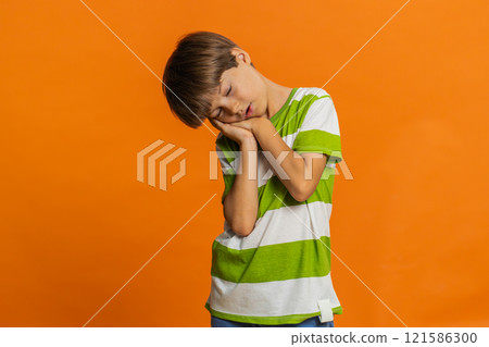 Tired child boy kid going to sleep laying down on his palms taking nap resting falling asleep 121586300