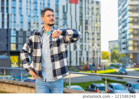 Serious sad mature businessman standing outdoors looking around waiting for business meeting Serious sad mature businessman standing outdoors looking around waiting for business meeting 121586340