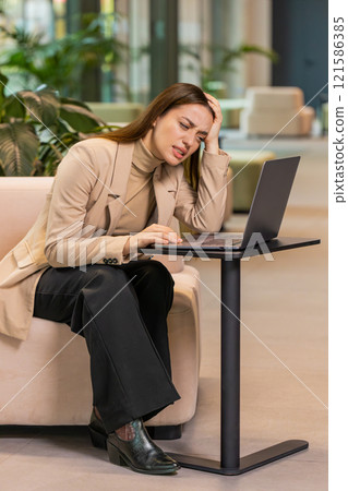 Caucasian businesswoman girl using laptop surprised by bad news, fortune loss, fail, lottery results 121586385