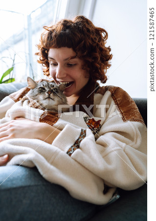 portrait young woman hugging gray fluffy domestic cat 121587465