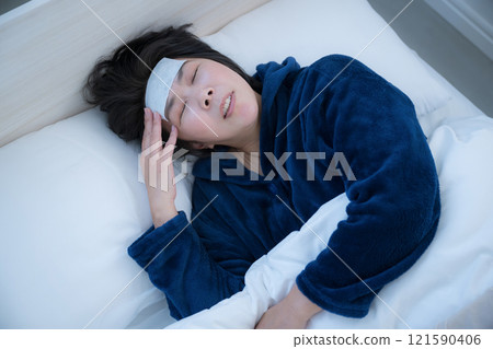A bird's-eye view of a middle-aged woman who has caught a cold and is in bed, cooling her head, saying, "Oh, I've got a fever." 121590406