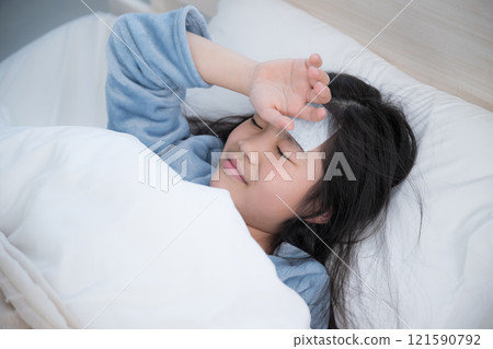 A child who has a fever and cools his head, catches a cold, and stays in bed A child who has a fever and cools his head, catches a cold, and stays in bed 121590792