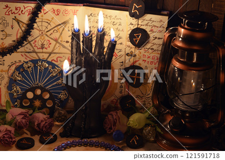 Mystic still life with runes, pentagram and magic spell book on old altar table. Occult, esoteric, wicca, Halloween and gothic concept. No foreign language, all symbols are fictional. 121591718