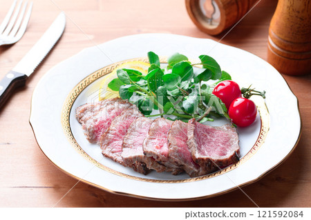 Roast beef cut and arranged on a plate 121592084