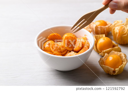 Cape gooseberry or Golden berry (Physalis peruviana) with chili powder and sugar, Spicy fruit salad 121592792