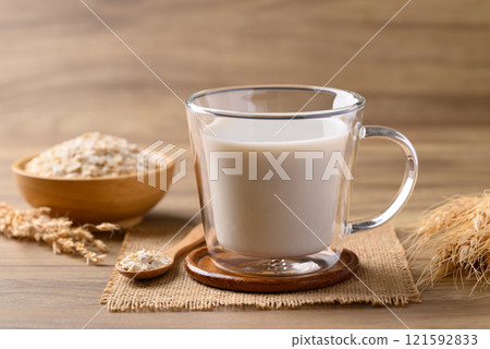 Oat milk in cup glass on wooden background, Alternative milk made from plant, non dairy 121592833