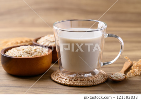 Oat milk in cup glass on wooden background, Alternative milk made from plant, non dairy 121592838