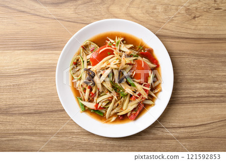 Spicy papaya salad (Som Tum), Local Thai food, Table top view Spicy papaya salad (Som Tum), Local Thai food, Table top view 121592853