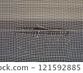 Image of a torn screen door 121592885