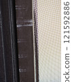 Image of a torn screen door 121592886