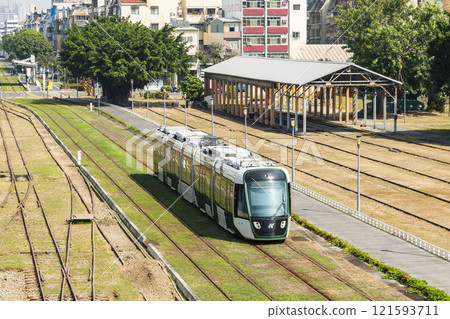 The circular light rail train drives past the former Kaohsiung Port Station North Signal Box, Taiwan. The circular light rail train drives past the former Kaohsiung Port Station North Signal Box, Taiwan. 121593711