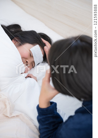Image of a mother nursing her child with a cold, vertical Image of a mother nursing her child with a cold, vertical 121593888