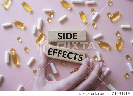 Side Effects symbol. Wooden blocks with words Side Effects. Beautiful pink background with pills. Doctor hand. Medicine and Side Effects concept. Copy space. Side Effects symbol. Wooden blocks with words Side Effects. Beautiful pink background with pills. Doctor hand. Medicine and Side Effects concept. Copy space. 121593919