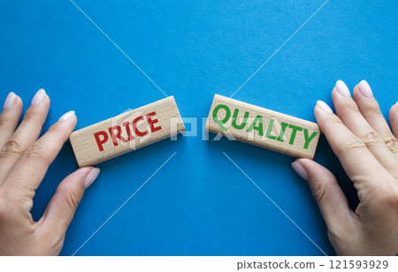 Price or Quality symbol. Concept word Price or Quality on wooden blocks. Businessman hand. Beautiful blue background. Business and Price or Quality concept. Copy space 121593929