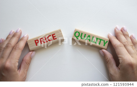 Price or Quality symbol. Concept word Price or Quality on wooden blocks. Businessman hand. Beautiful white background. Business and Price or Quality concept. Copy space Price or Quality symbol. Concept word Price or Quality on wooden blocks. Businessman hand. Beautiful white background. Business and Price or Quality concept. Copy space 121593944