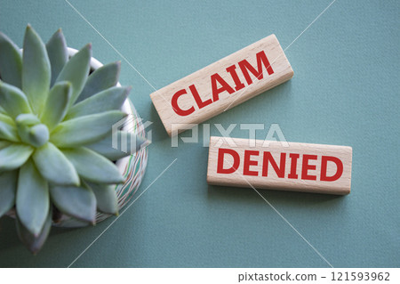 Claim denied symbol. Wooden blocks with words Claim denied. Beautiful grey green background with succulent plant. Business and Claim denied concept. Copy space. Claim denied symbol. Wooden blocks with words Claim denied. Beautiful grey green background with succulent plant. Business and Claim denied concept. Copy space. 121593962