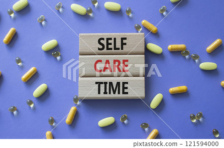 Self-care Time symbol. Concept words Self-care Time on wooden blocks. Beautiful purple background with pills. Healthcare and Self-care Time concept. Copy space. Self-care Time symbol. Concept words Self-care Time on wooden blocks. Beautiful purple background with pills. Healthcare and Self-care Time concept. Copy space. 121594000
