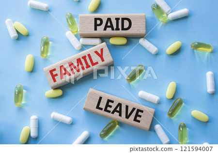 Paid Family Leave symbol. Concept words Paid Family Leave on wooden blocks. Beautiful blue background with pills. Healthcare and Paid Family Leave concept. Copy space. Paid Family Leave symbol. Concept words Paid Family Leave on wooden blocks. Beautiful blue background with pills. Healthcare and Paid Family Leave concept. Copy space. 121594007