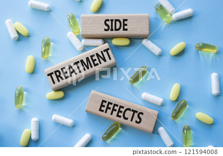 Side Treatment Effects symbol. Concept words Side Treatment Effects on wooden blocks. Beautiful blue background with pills. Healthcare and Side Treatment Effects concept. Copy space. 121594008