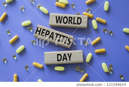 World Hepatitis Day symbol. Concept words World Hepatitis Day on wooden blocks. Beautiful purple background with pills. Healthcare and World Hepatitis Day concept. Copy space. World Hepatitis Day symbol. Concept words World Hepatitis Day on wooden blocks. Beautiful purple background with pills. Healthcare and World Hepatitis Day concept. Copy space. 121594014