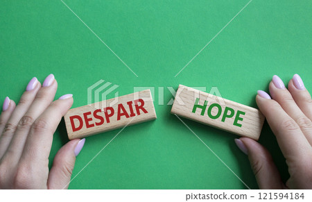 Despair or Hope symbol. Concept word Despair or Hope on wooden blocks. Businessman hand. Beautiful green background. Business and Despair or Hope concept. Copy space Despair or Hope symbol. Concept word Despair or Hope on wooden blocks. Businessman hand. Beautiful green background. Business and Despair or Hope concept. Copy space 121594184