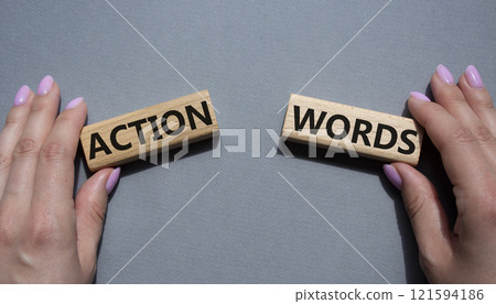 Action or words symbol. Concept word Action or words on wooden blocks. Businessman hand. Beautiful grey background. Business and Action or words concept. Copy space 121594186