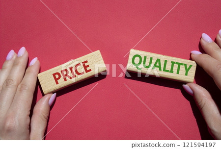 Price and Quality symbol. Concept word Price and Quality on wooden blocks. Businessman hand. Beautiful red background. Business and Price and Quality concept. Copy space Price and Quality symbol. Concept word Price and Quality on wooden blocks. Businessman hand. Beautiful red background. Business and Price and Quality concept. Copy space 121594197