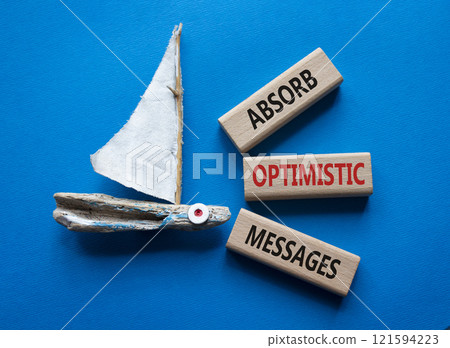 Absorb optimistic Messages symbol. Concept words Absorb optimistic Messages on wooden blocks. Beautiful blue background with boat. Business and Absorb optimistic Messages concept. Copy space. 121594223