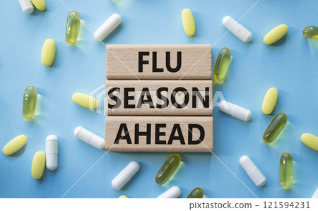 Flu Season Ahead symbol. Concept word Flu Season Ahead on wooden blocks. Beautiful blue background with pills. Medicine and Flu Season Ahead concept. Copy space Flu Season Ahead symbol. Concept word Flu Season Ahead on wooden blocks. Beautiful blue background with pills. Medicine and Flu Season Ahead concept. Copy space 121594231